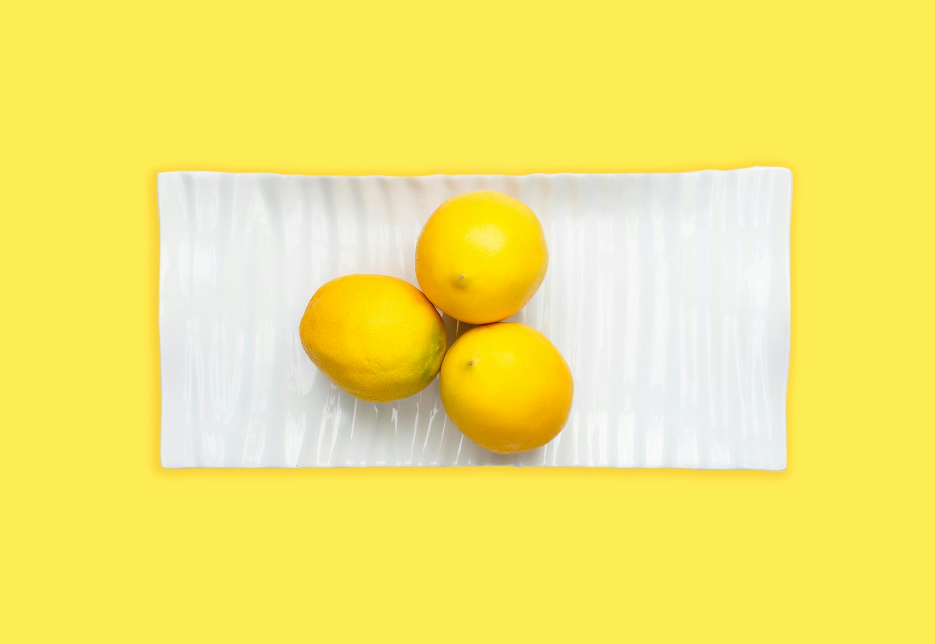 Two people laughing together with lemons and plants, expressing joy and comfort in intimate moments