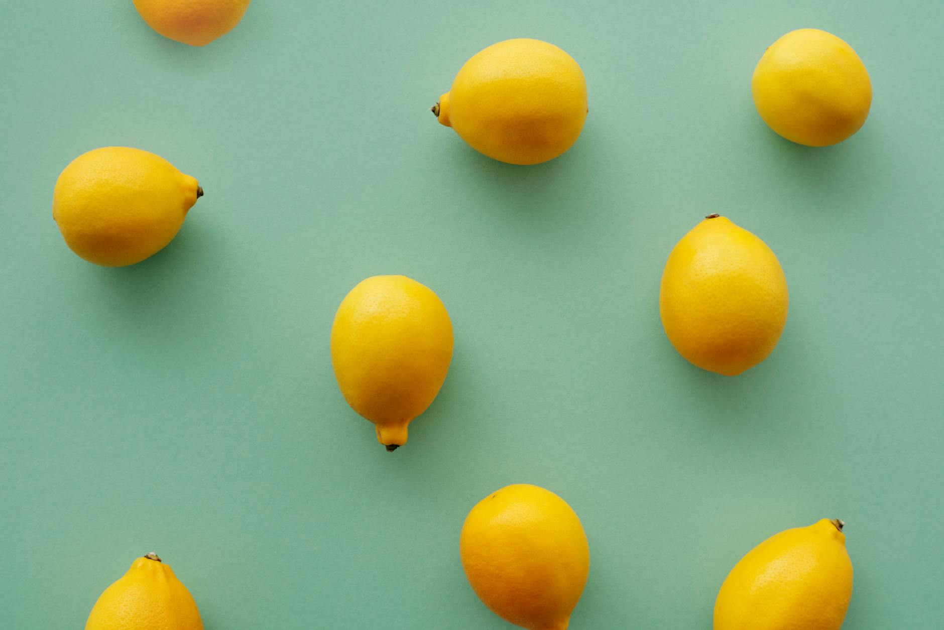 Bright yellow lemons arranged on a pastel green background, symbolizing the phases of pleasure and hormonal change