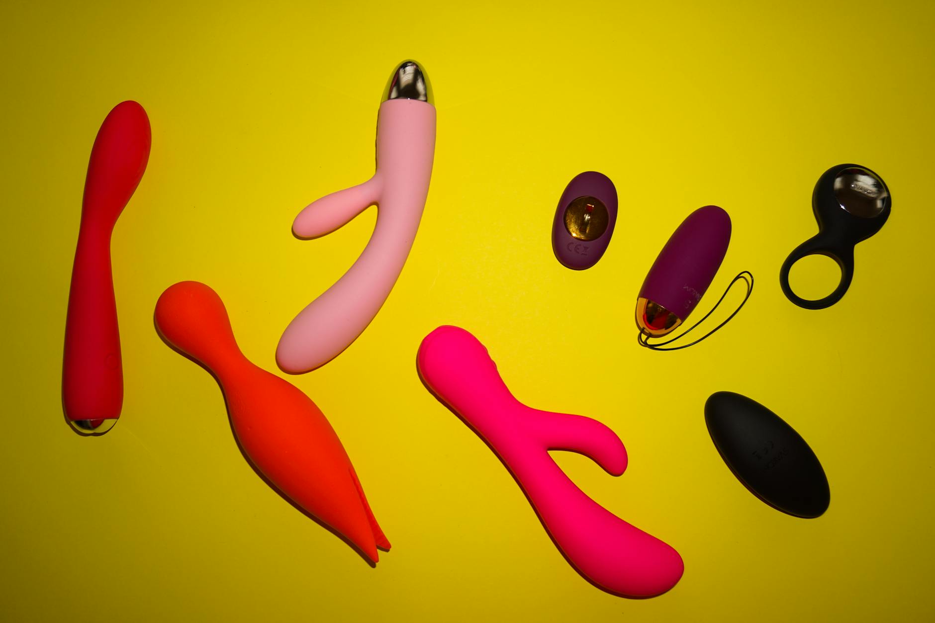 Hands holding a blue silicone clitoral vibrator, symbolizing gentle self-touch and postpartum pleasure restoration