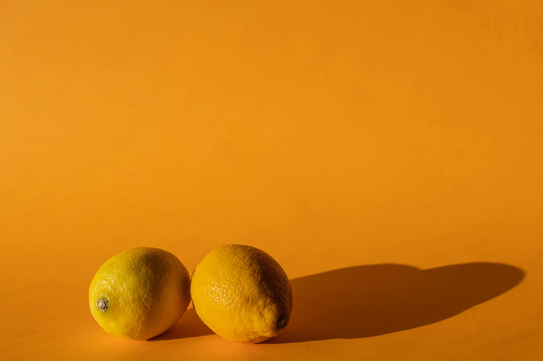 Ripe vivid lemons composed on yellow background representing fresh starts and renewal